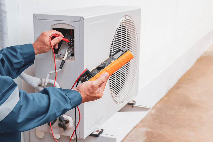 HVAC technician testing AC unit